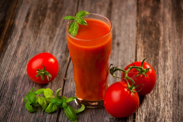 Tomato Juice with Tomatoes and Basil on Wood