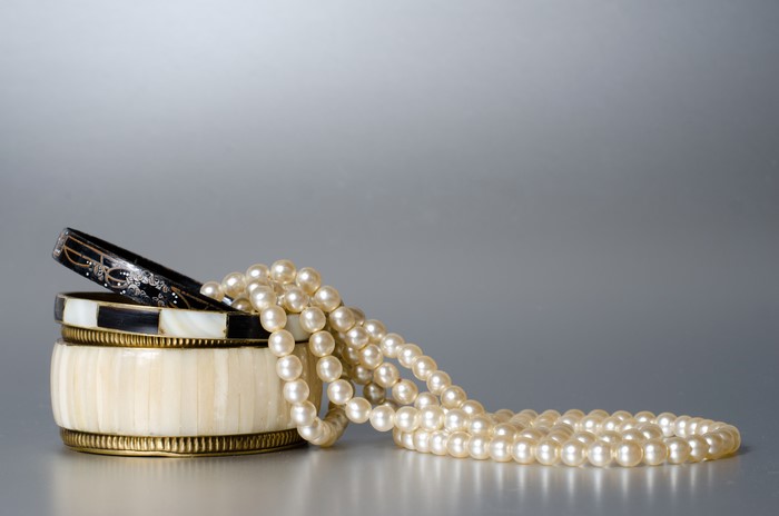 Jewelry with Pearls and Bracelets on Gray Background
