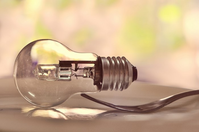 Light bulb on a fork on a plate