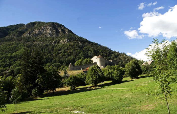 Fortress on a grassy hill in the Alps