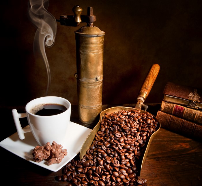 Coffee cup, grinder, beans, and books