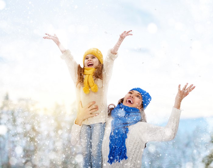 Mother and Daughter Enjoying Snowfall