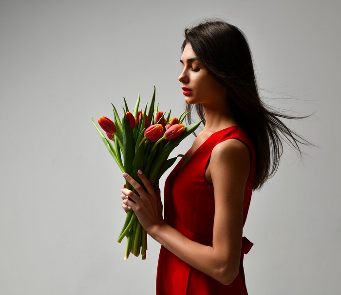 Woman in red dress holding tulips
