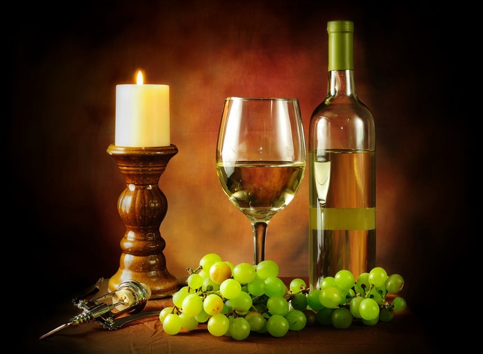 Still-life with wine, grapes, and candle