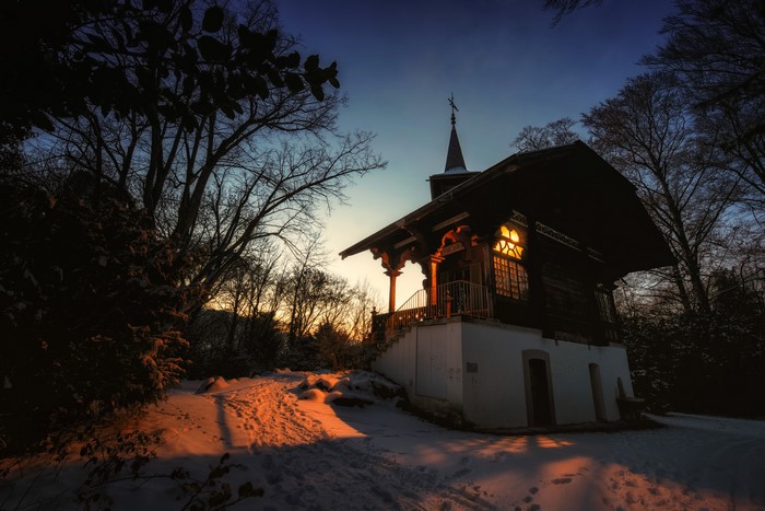 Chapel in the snow at sunset in Switzerland