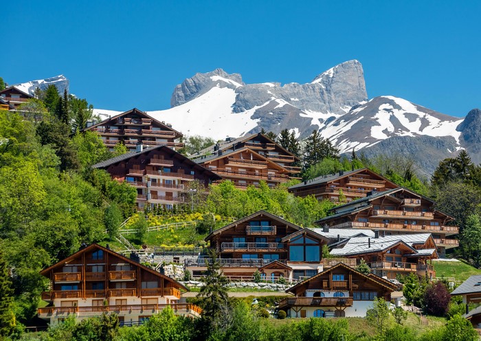 Wooden chalets on a mountainside in Bluche Crans-Montana, Switzerland
