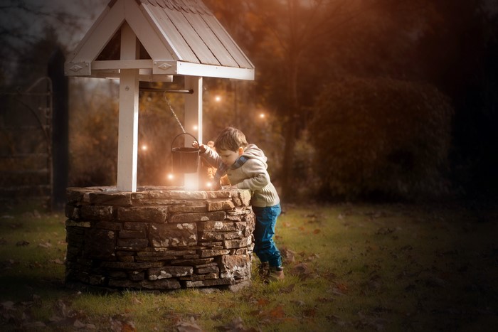 Boy at a Water Well with Lights