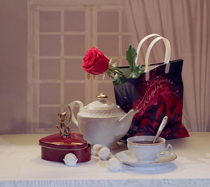 Still life with rose, tea set, and candies