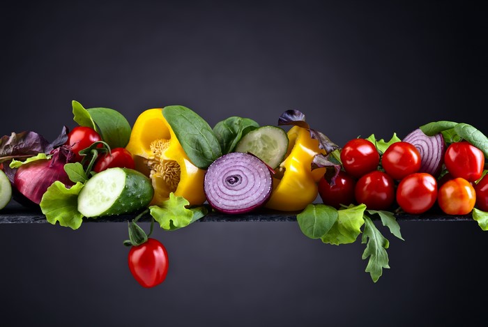 Vegetables: Tomatoes, Bell Pepper, Cucumbers, Onion, Gray Background