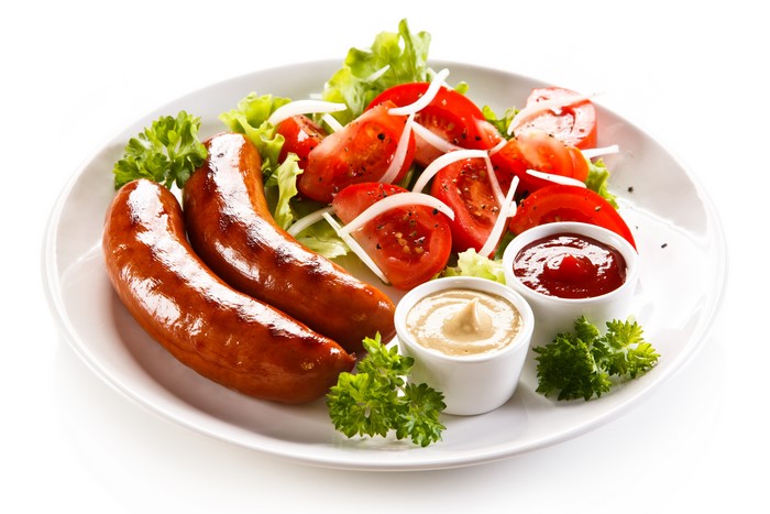 Sausages with tomato and onion salad and dips