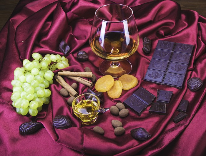 Alcoholic drink with chocolate, grapes, and cinnamon