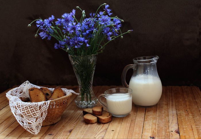 Still life with cornflowers, milk, and bread