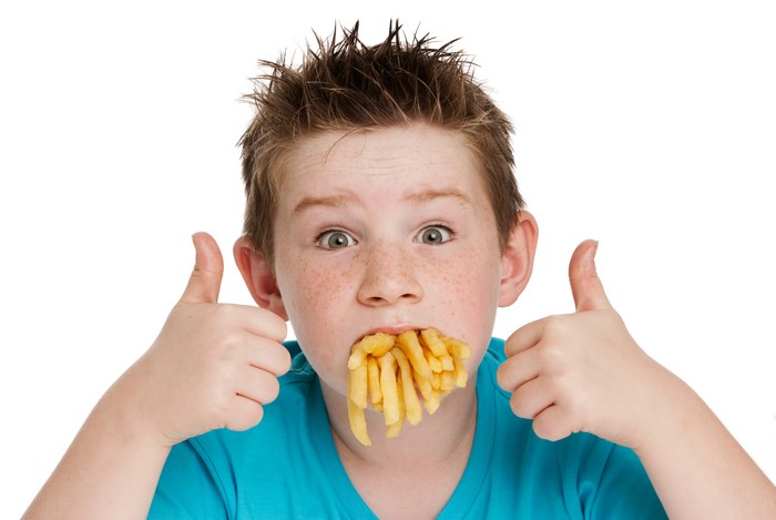 Boy with French Fries in Mouth Giving Thumbs Up
