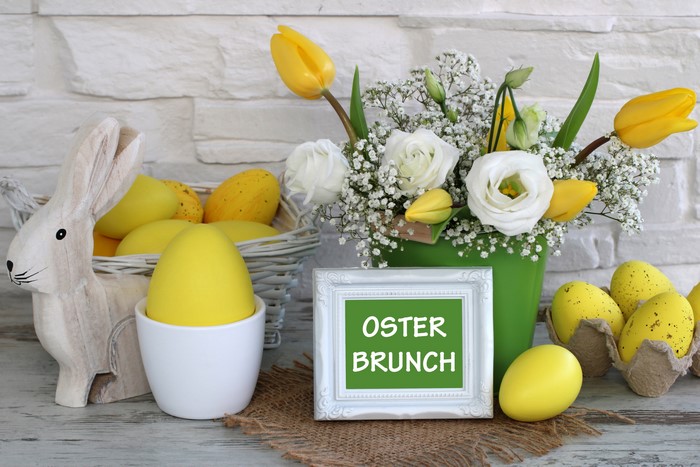 Easter Brunch Decoration with Yellow Eggs and Flowers