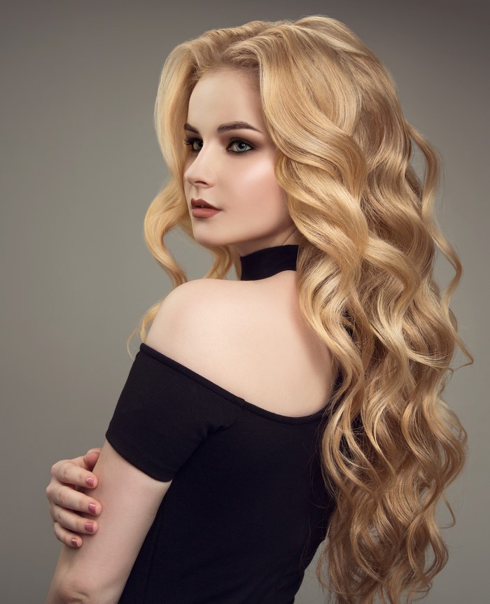 Blonde woman with curly hair and makeup