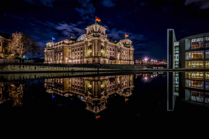 Reichstag Building reflected in water at night