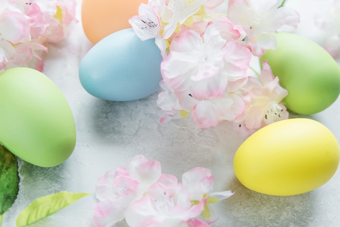 Easter eggs and flowers on a textured surface