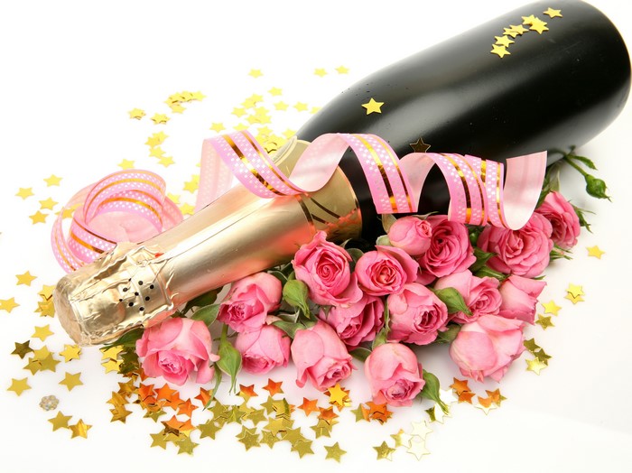 Champagne bottle with pink roses and star decorations