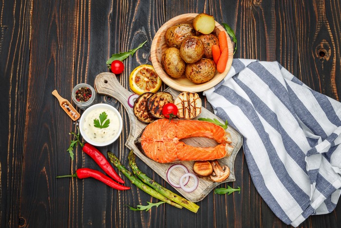 Salmon steak with roasted potatoes and vegetables