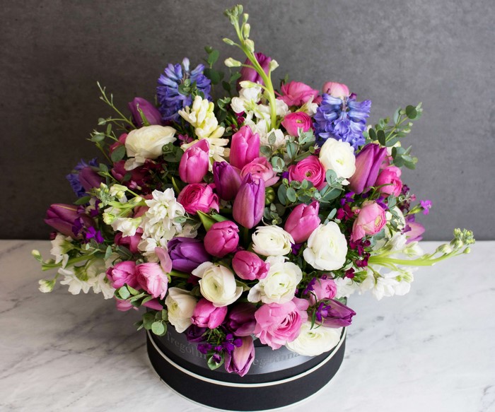Pink and purple flower bouquet in a black box