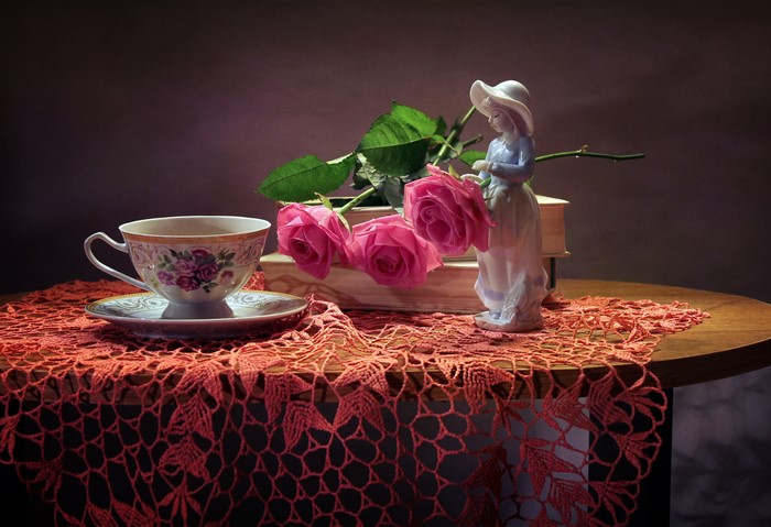 Still life with roses, cup, and figurine