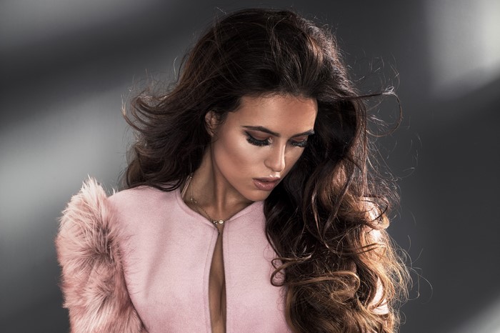 Brown haired woman in pink coat