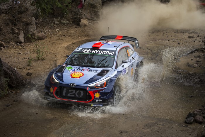 Hyundai i20 Coupe WRC car driving through mud
