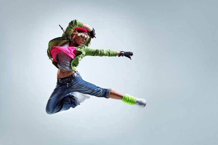 Blonde girl in jeans jumping