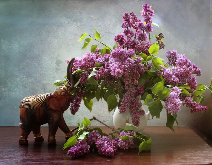 Still-life with lilac bouquet and wooden elephant