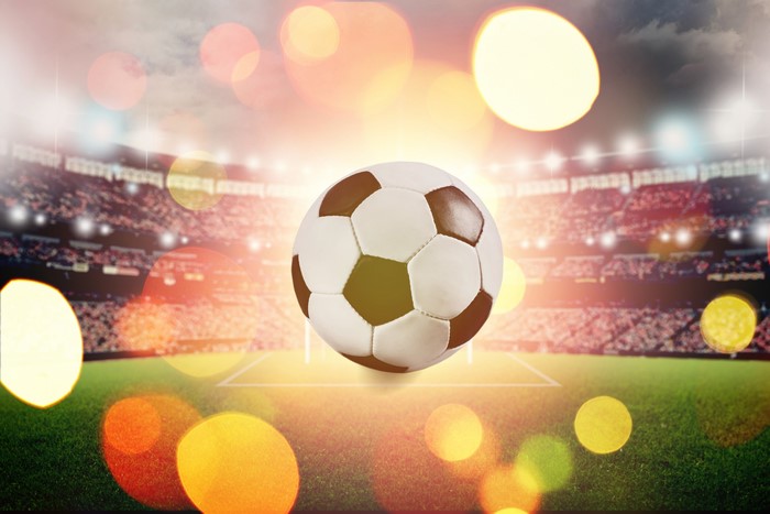 Soccer ball in stadium with bokeh lights
