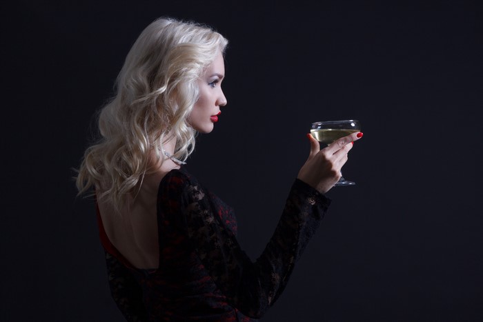 Blonde woman holding a glass of wine