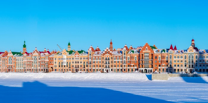 Colorful houses on a snowy embankment in Yoshkar-Ola, Russia