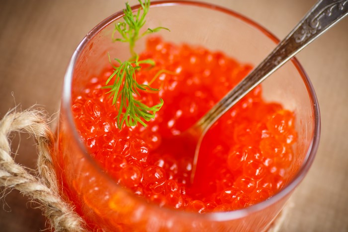 Red Caviar in a Glass with Dill and Spoon