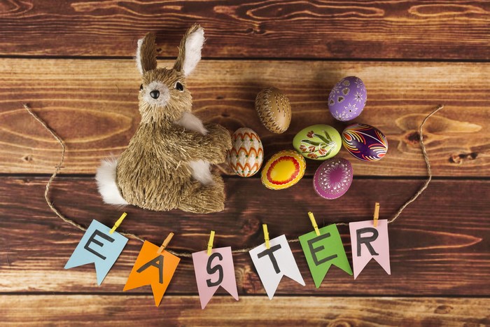 Easter bunny and decorated eggs on wooden planks