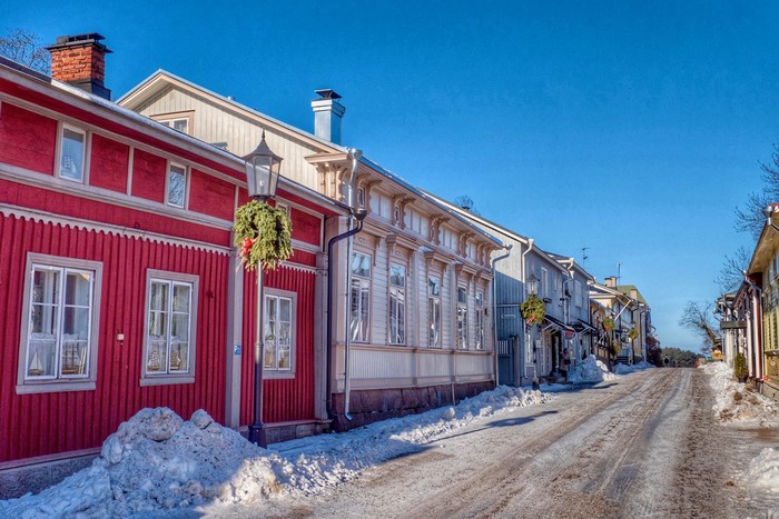 Winter street with snow and decorated houses in Naantali, Finland