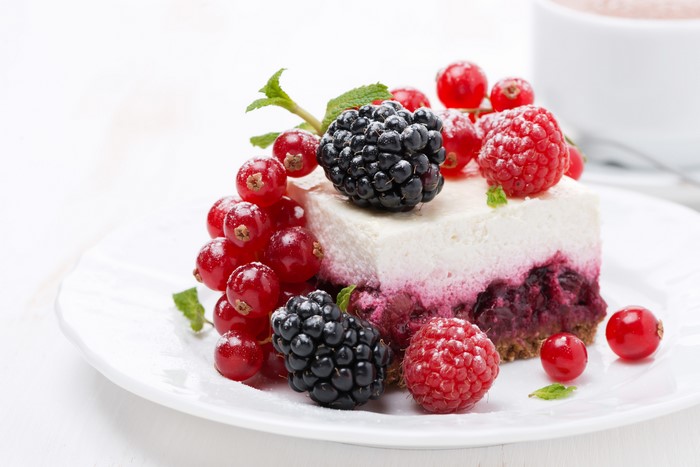 Slice of cake with berries and mint