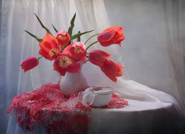 Red Tulips in a White Vase on a Table