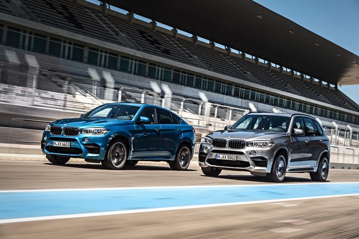 Two BMW M SUVs on a Race Track