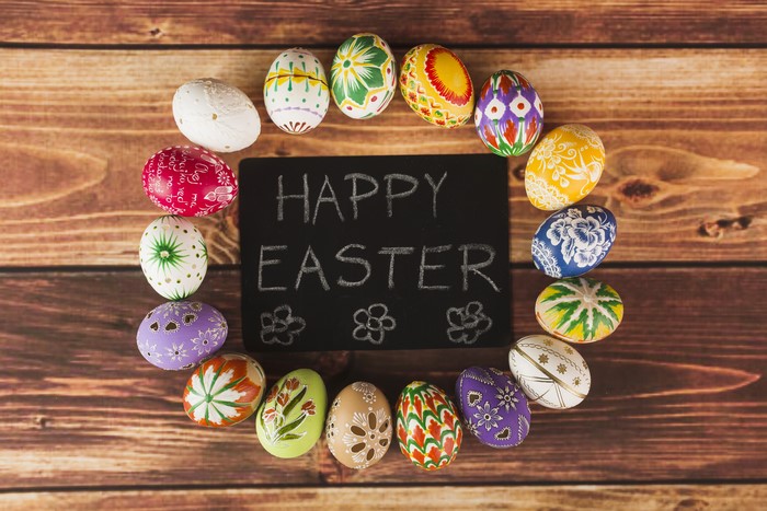 Easter eggs arranged around a chalkboard with Happy Easter message