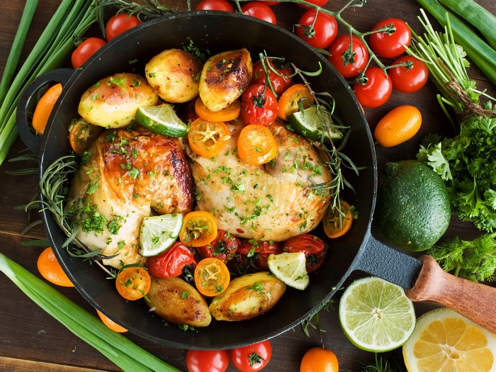 Roast Chicken with Potatoes and Tomatoes in Frying Pan