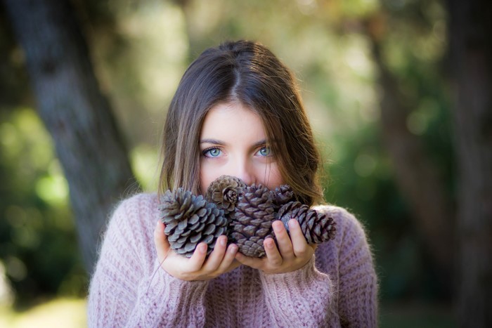 Woman holding pine cones