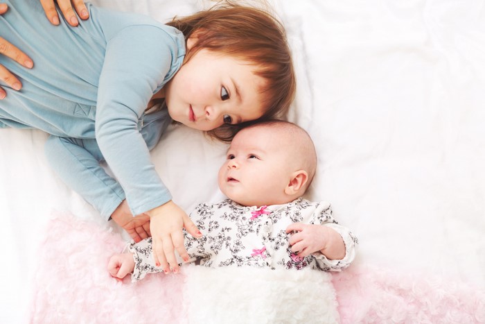 Two little girls, one infant, hands