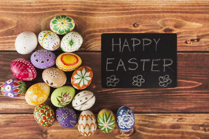 Easter Eggs on Wooden Planks with Happy Easter Chalkboard