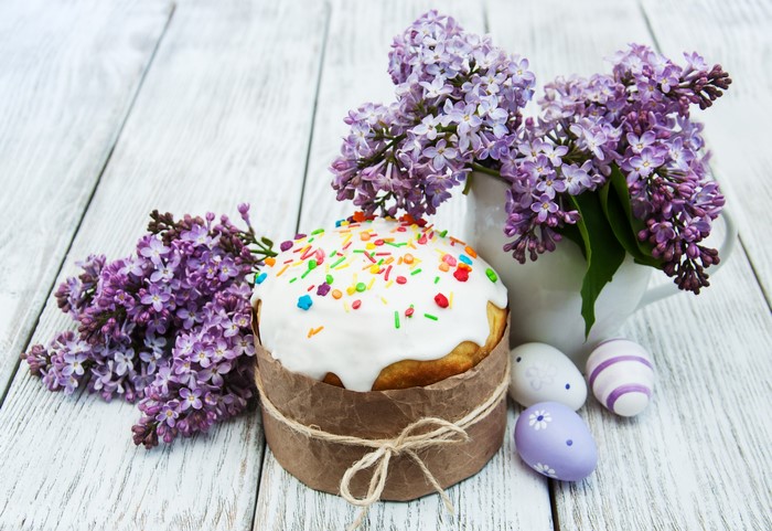 Easter Kulich with Lilacs and Eggs on Wooden Table
