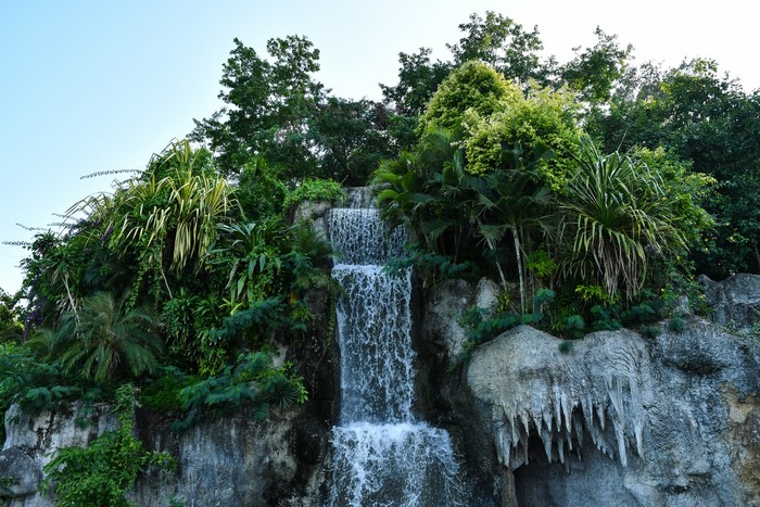 Waterfalls and lush vegetation on a rocky crag
