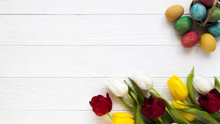Easter Eggs and Tulips on White Wood Planks