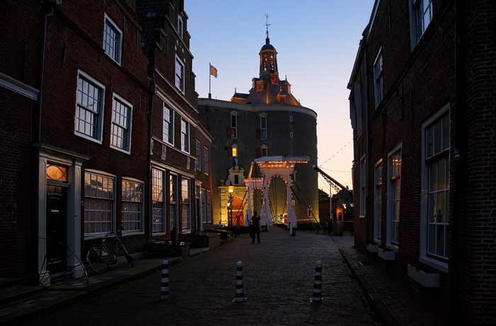Enkhuizen Netherlands Street with Bridge and Tower at Dusk