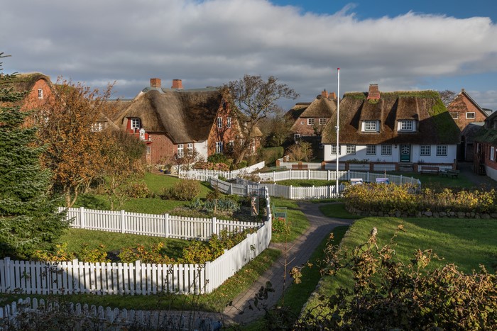 Thatched roof houses and white fences in Germany