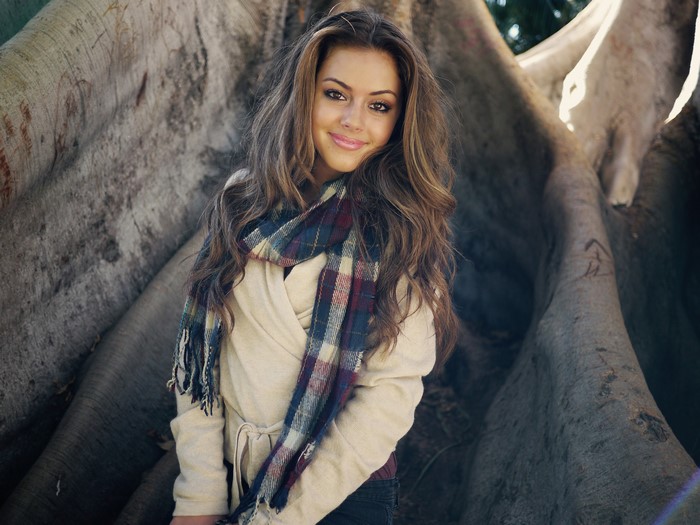 Young woman with brown hair wearing a scarf