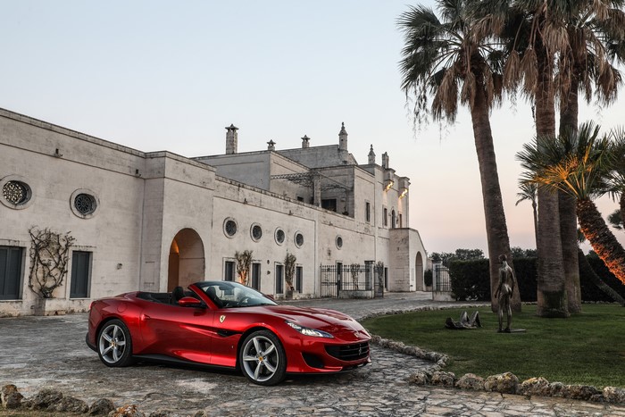 Red Ferrari Portofino Cabriolet in front of a building